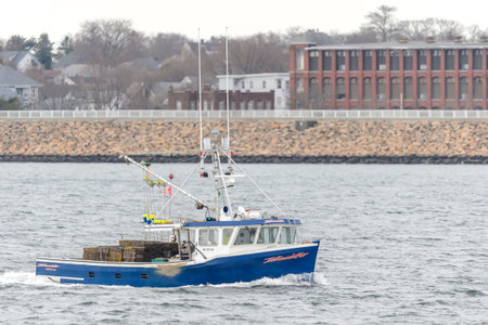 New Bedford, Massachusetts, USA - December 12, 2017: Fishing vessel Intimidator on Acushnet River with New Bedford backdropのeditorial素材