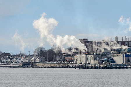 New Bedford, Massachusetts, USA - December 15, 2017: Clouds of steam rising from factory along harbor on cold day in New Bedford, Massachusettsのeditorial素材
