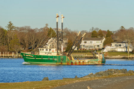 New Bedford, Massachusetts, USA - December 21, 2017: Fishing vessel Ilha Brava on the Acushnet River with Fairhaven in backgroundのeditorial素材