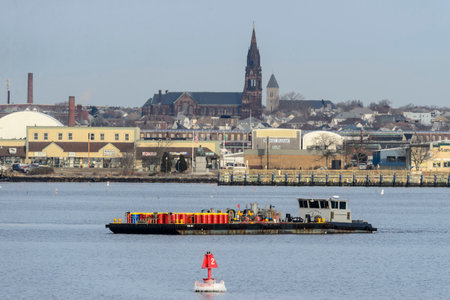 New Bedford, Massachusetts, USA - December 30, 2017: Fuel barge crossing Acushnet River from...