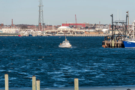 Fairhaven, Massachusetts, USA - January 1, 2018: Small boat crossing Acushnet River on windy winter morningのeditorial素材