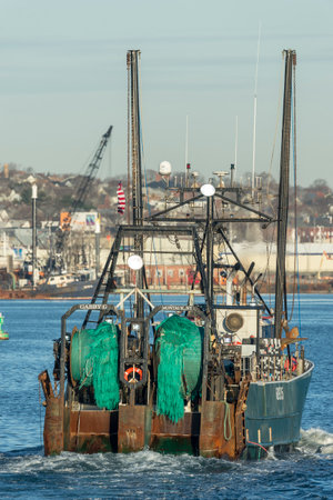 New Bedford, Massachusetts, USA - December 21, 2017: Fishing vessel Gabby G., hailing port Montauk, New York,  entering New Bedford harbor (vertical format)のeditorial素材