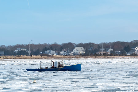 Fairhaven, Massachusetts, USA - January 11, 2018: Fishing boat moored in icy water off West Islandのeditorial素材
