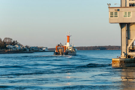 Cape Cod Canal, Massachusetts, USA - March 4, 2007: Fishing vessel Sunlight on Cape Cod Canal in dawn lightのeditorial素材