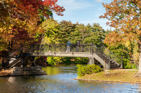 Roger Williams Park, Rhode Island, USA - October 13, 2009: Two men on footbridge overlooking Pleasure Lake in Roger Williams Parkのeditorial素材