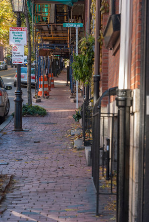 Boston, Massachusetts, USA - November 24, 2007: Tight quarters on Beacon Hill with uneven brick sidewalk and construction scaffoldingのeditorial素材