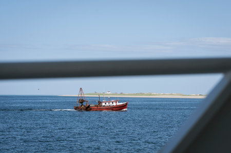 Provincetown, Massachusetts, USA - June 2, 2008: Fishing boat Ancora Praia off Provinctown framed by...