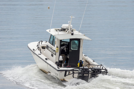 Fairhaven, Massachusetts, USA - May 1, 2019: Patrol boat surges ahead as Fairhaven Harbormaster...