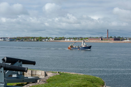 New Bedford, Massachusetts, USA - May 15, 2019: Commercial fishing vessel Nobska crossing New Bedford outer harbor under cloudy skiesのeditorial素材