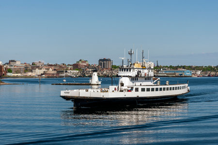 Fairhaven, Massachusetts, USA - May 16, 2019: Vehicle ferry Governor passing Palmer Island Light...