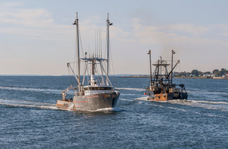 New Bedford, Massachusetts, USA - September 3, 2019: Commercial fishing vessels Fortune Hunter and Tropico passing on summer morning in New Bedford outer harborのeditorial素材