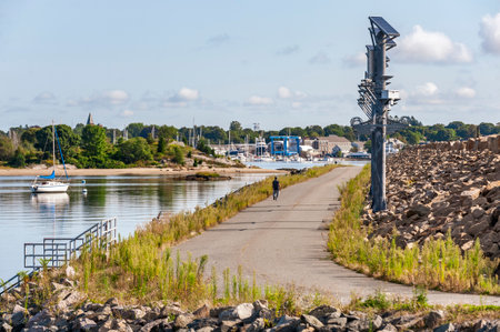 New Bedford, Massachusetts, USA - September 10, 2019: Man walking along road on hurricane barrier...