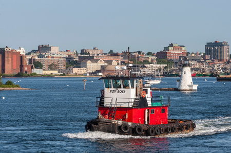 New Bedford, Massachusetts, USA - August 2, 2019: Tug Roy Boys passing lighthouse on her way out of New Bedford harborのeditorial素材