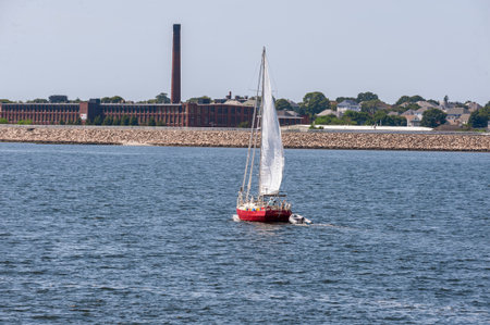 New Bedford, Massachusetts, USA â July 26, 2019: Sailboat working her way along  New Bedford shorelineのeditorial素材