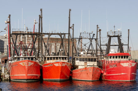 New Bedford, Massachusetts, USA - November 30, 2019: Line of commercial fishing boats docked at Pier...