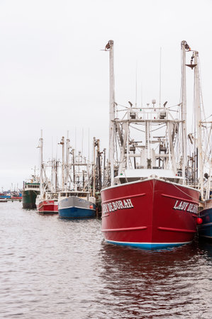New Bedford, Massachusetts, USA - August 17, 2019: Docked fishing boats on cloudy summer morning in...