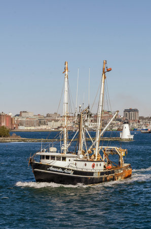 New Bedford, Massachusetts, USA - March 14, 2020: Commercial fishing boat Amanda Ashley, hailing port Aurora, NC, passing  Palmer Island Light Stationのeditorial素材