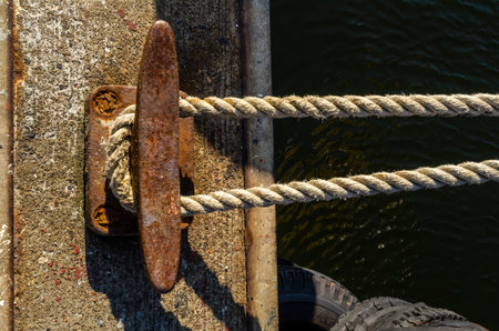 Taut line securing fishing boat to wharf
