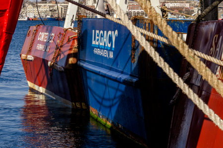 Fairhaven, Massachusetts, USA - March 22, 2020: Sterns of docked commercial fishing boats Contender...