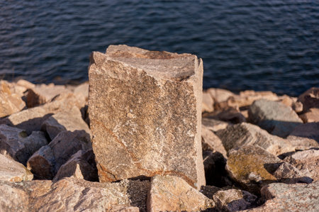 Granite stone set as marker along service road on hurricane barrier across New Bedford harbor