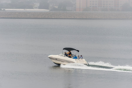 New Bedford, Massachusetts, USA - September 15, 2018: Powerboat cruising across smooth Acushnet...
