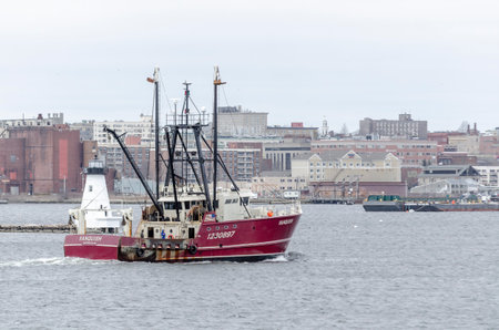 Fairhaven, Massachusetts, USA - April 1, 2020: Scalloper Vanquish homebound on hazy spring morningのeditorial素材