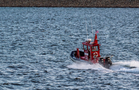New Bedford, Massachusetts, USA - June 25, 2018: Small towboat rocketing acrosss choppy water in New...