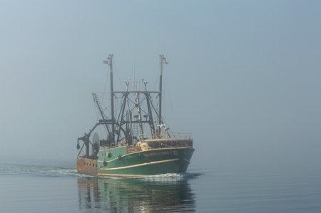 New Bedford, Massachusetts, USA - May 9, 2018: Commercial fishing vessel Vila Nova do Corvo I approaching New Bedford hurricane barrier on foggy morningのeditorial素材