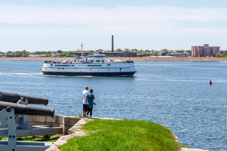 Fairhaven, Massachusetts, USA - May 21, 2018: Man and woman watch M/V Nantucket making her way up the Acushnet River off Fort Phoenixのeditorial素材