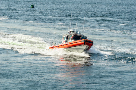 Fairhaven, Massachusetts, USA - May 25, 2018: Fairhaven Fire Department patrol boat busts through wake while heading back to port from Buzzards Bayのeditorial素材