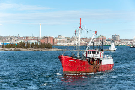 Fairhaven, Massachusetts, USA - April 20, 2018: Commercial fishing vessel Michigan, a 1940s era steel trawler converted to a scalloper, crossing New Bedford inner harborのeditorial素材
