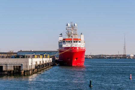 New Bedford, Massachusetts, USA - May 13, 2020: Brightly colored hull of docked research vessel Fugro Searcher glowing in early morning sunlightのeditorial素材