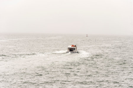 New Bedford, Massachusetts, USA - May 27, 2020: Cuttyhunk water taxi Seahorse outbound into fog in Buzzards Bayのeditorial素材