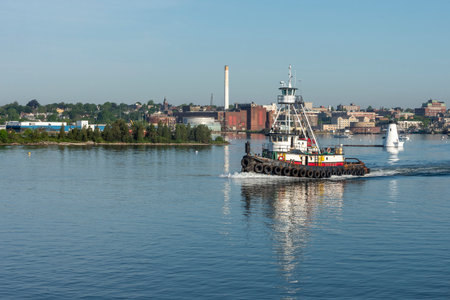 New Bedford, Massachusetts, USA - June 4, 2020: Tug Realist passing lighthouse on her way out of New Bedfordのeditorial素材
