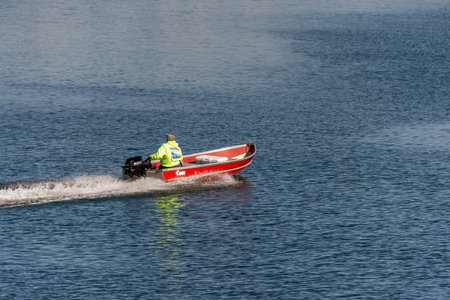 New Bedford, Massachusetts, USA - May 21, 2020: Man in skiff skimming across New Bedford harborのeditorial素材