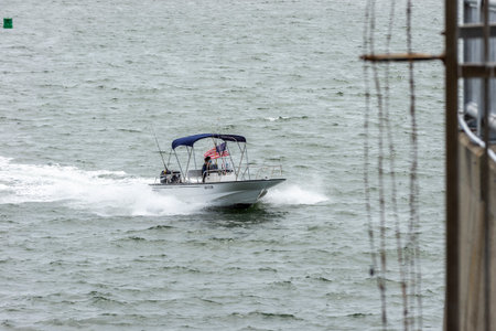 New Bedford, Massachusetts, USA - June 2, 2020: Center console recreational fishing boat gliding...