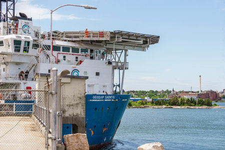 New Bedford, Massachusetts, USA - June 2, 2020: Crewman walking alongside helipad over boat's bridge as drilling vessel Geoquip Saentis transits hurricane barrierのeditorial素材