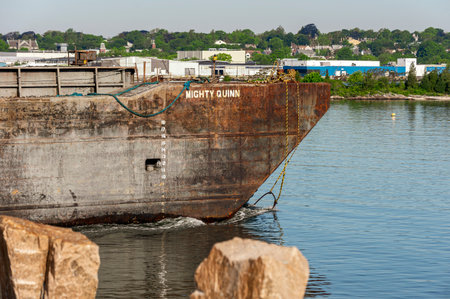 New Bedford, Massachusetts, USA - June 4, 2020: Tug Kendall J. Hebert (not shown) pushing the barge Mighty Quinn through the hurricane barrierのeditorial素材