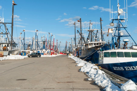 New Bedford, Massachusetts, USA - March 15, 2018: Rows of fishing boats line pier along New Bedford waterfrontのeditorial素材