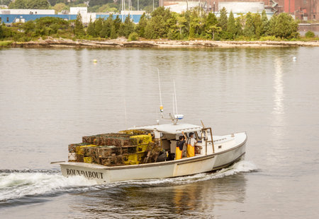 New Bedford, Massachusetts, USA - September 15, 2018: Lobster boat Roundabout, hailing port Mattapoisett, Massachusetts, crossing New Bedford inner harbor with load of lobster potsのeditorial素材
