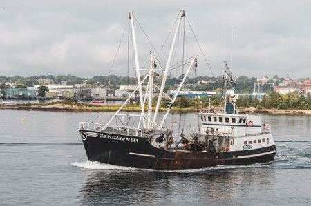 New Bedford, Massachusetts, USA - September 15, 2018: Eastern rig scalloper Christian & Alexa with New Bedford waterfront in backgroundのeditorial素材