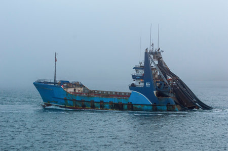 New Bedford, Massachusetts, USA - September 11, 2018: Commercial fishing vessel Sea Watcher I heading out into the fog on Buzzards Bayのeditorial素材