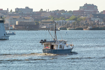 New Bedford, Massachusetts, USA - September 5, 2018: Motor yacht Emily Grace, hailing port Padanaram, Massachusetts, passing lighthouse in New Bedford harborのeditorial素材