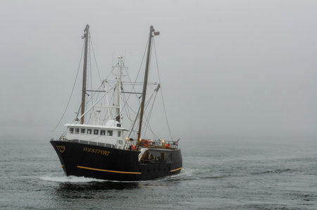 New Bedford, Massachusetts, USA - April 4, 2018: Fishing vessel Westport approaching hurricane barrier through fog in New Bedford inner harborのeditorial素材