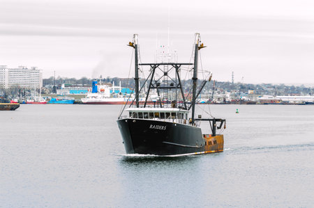 New Bedford, Massachusetts, USA - March 28, 2018: Fishing vessel Raiders leaving New Bedford harborのeditorial素材