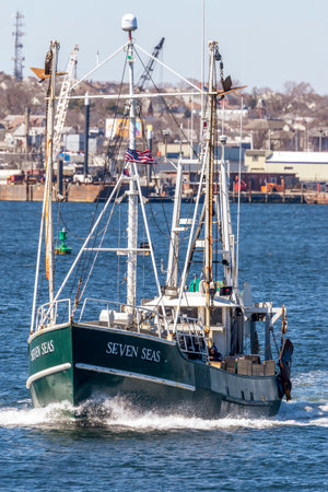New Bedford, Massachusetts, USA - March 31, 2018: Trawler Seven Seas cutting through a wake in New Bedford inner harborのeditorial素材