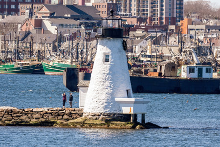 New Bedford, Massachusetts, USA - March 31, 2018: Two people enjoying an early spring afternoon at Palmer Island lighthouseのeditorial素材