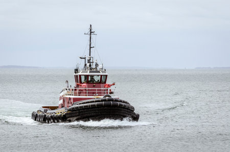 New Bedford, Massachusetts, USA - April 8, 2018: Tug Buckley McAllister, hailing port Wilmongton, DE, on her way into New Bedford on hazy morningのeditorial素材
