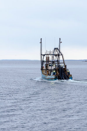 New Bedford, Massachusetts, USA - April 8, 2018: Clammer Lori Ann, hailing port  Cape May, NJ, on her way out of New Bedford in early eveningのeditorial素材