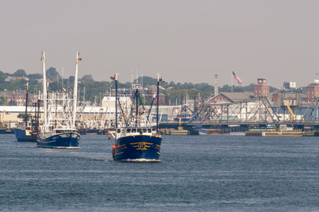 New Bedford, Massachusetts, USA - July 3, 2018: Commercial fishing vessel Luzitano leading short parade of boats on Acushnet Riverのeditorial素材